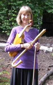 Gayle Neuman holding the viola da braccio (early violin) and tenor krummhorn