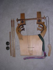 From right to left: kithara, pair of auloi, and syrinx monokalamos built by the Neumans; ancient kymbala.