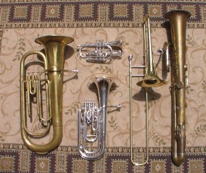 Some of the instruments played by the Pioneer Brass Band: Berliner valve tuba c. 1870, cornet, tenor horn, trombone c. 1890, ophicleide c. 1840