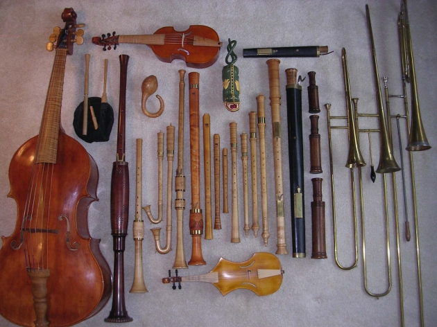 Some of the instruments played by Ensemble De Organographia. Top row, left to right: treble viol, alto curtal; 2nd row: bagpipe, gourd rattle, tartold, tenor alt rackett, tenor sackbutt, bass sackbutt, contrabass sackbutt; 3rd row: violone, tenor shawm, alto shawm, 2 schreierpfeiffen, 2 krummhorns, bass douçaine, 4 recorders, 3 cornamusen, bass Praetorius schreierpfeif, bass rackett, bass curtal; 4th row: great bass rackett; 5th row: viola da braccio, spinettino