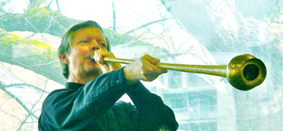 Phil Neuman demonstrates playing an ancient Greek horn.